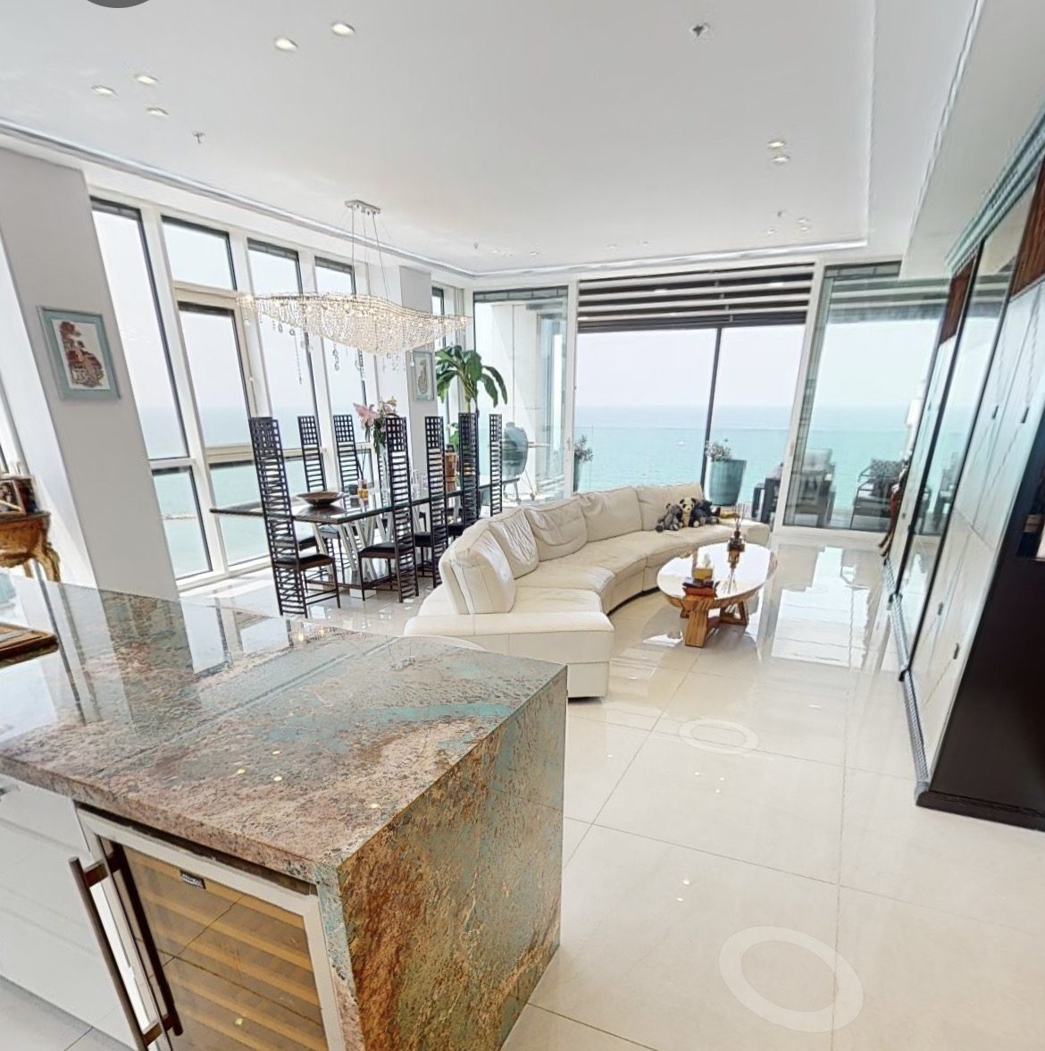 A large living room with a view of the ocean.