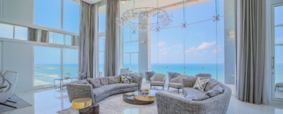 A living room with large windows overlooking the ocean.