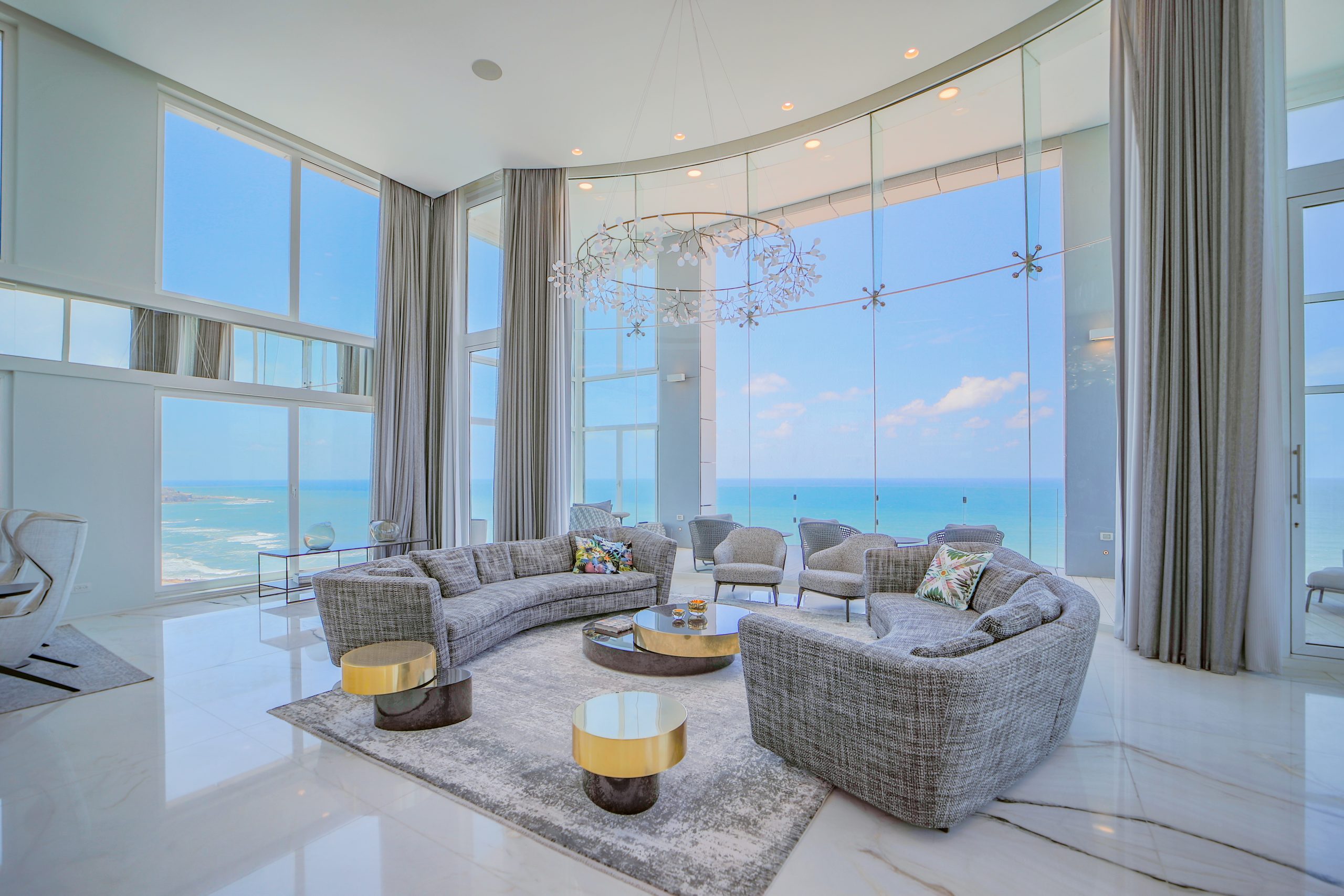A living room with large windows overlooking the ocean.