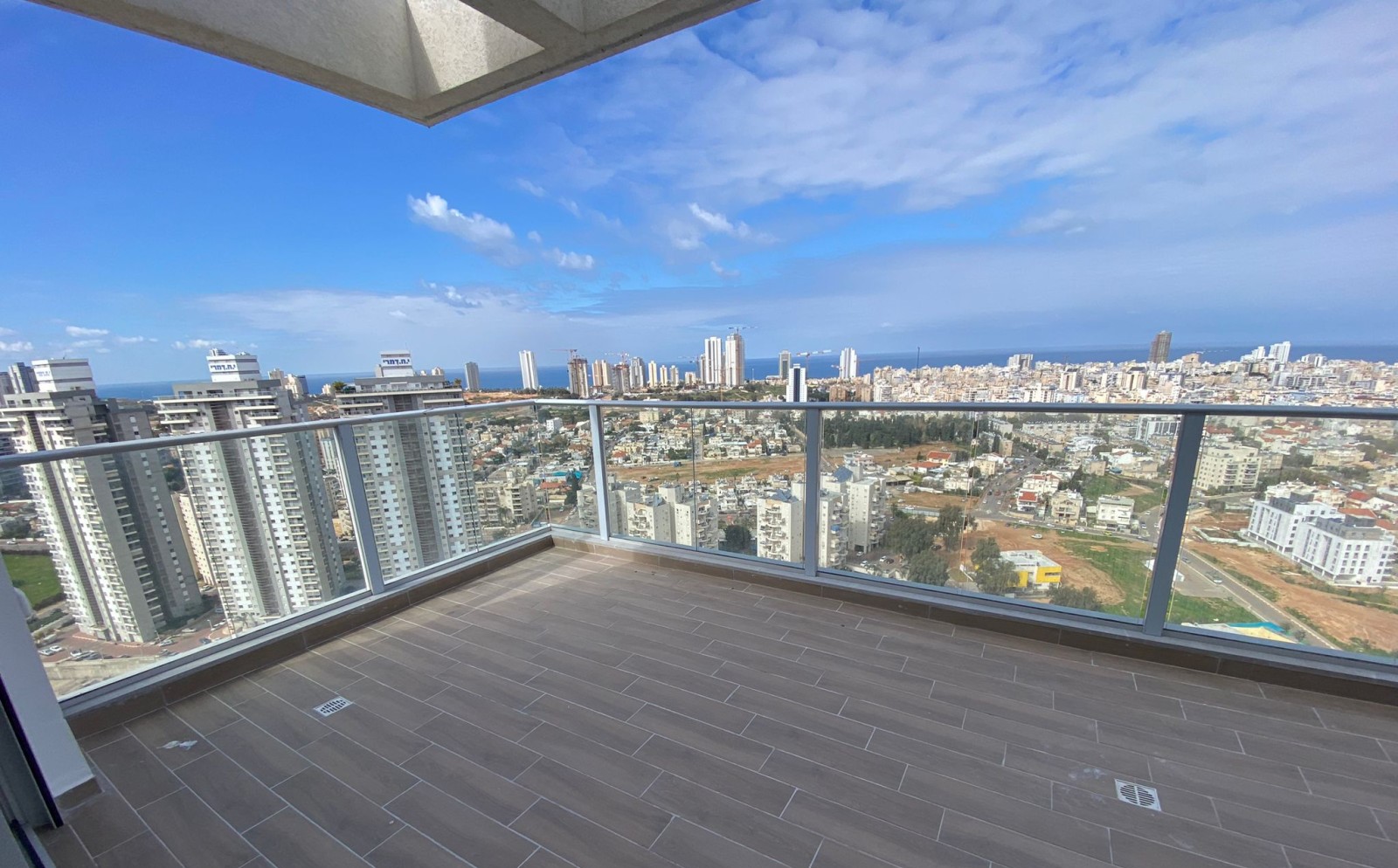 a balcony with a view of a city