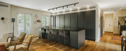 A kitchen and living room in a modern apartment.