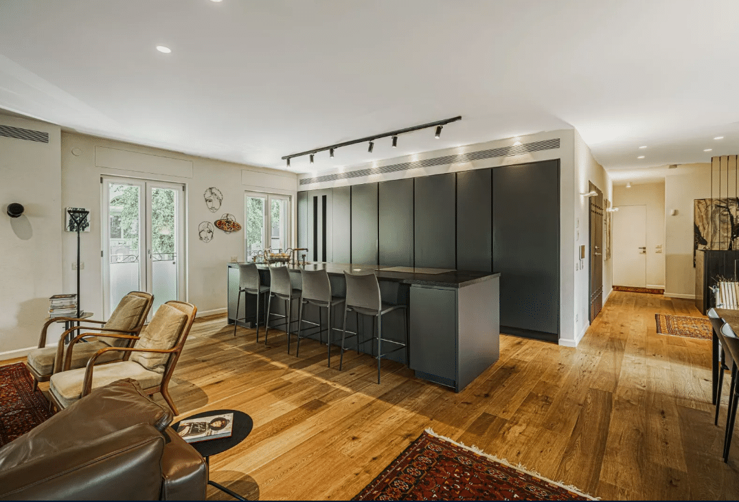 A kitchen and living room in a modern apartment.