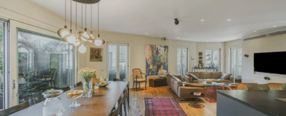 A living room with a dining table and a tv.