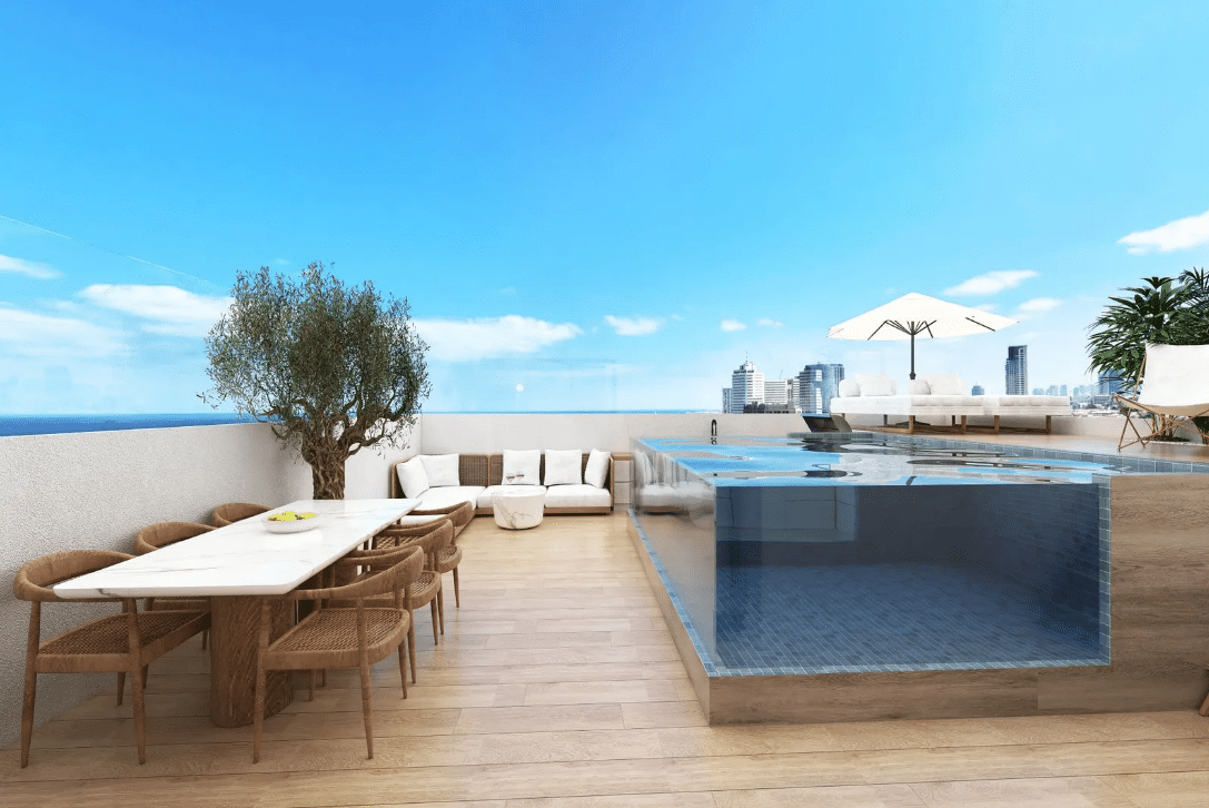 a rooftop patio with a glass pool and a white table and brown chairs
