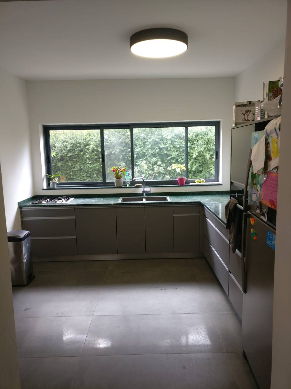 A kitchen with a sink and a window.